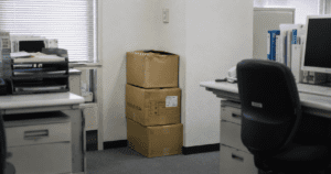 Why Is There Always a Cardboard Box in the Corner of a Japanese Office? Cardboard boxes sitting in the corner of a Japanese office, illustrating the cultural gap between Japanese and Western workplace aesthetics