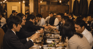 Nomikai: What the Guidebooks Don't Tell You Japanese office workers raising glasses for kanpai at a crowded izakaya after work.